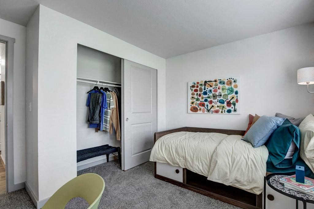a bedroom with a bed and a closet