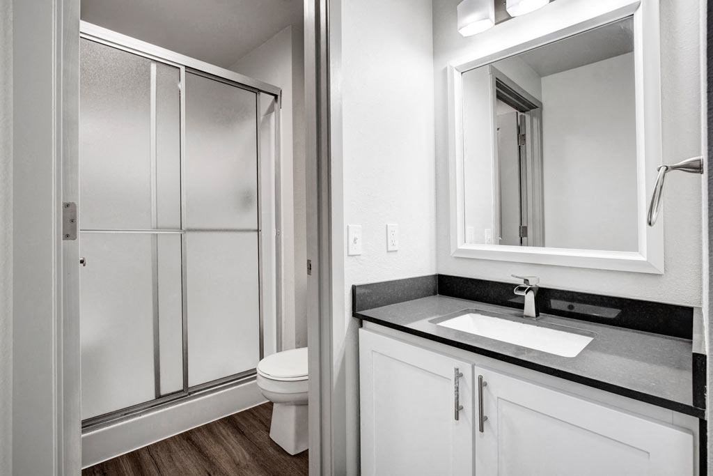 a bathroom with a sink toilet and shower