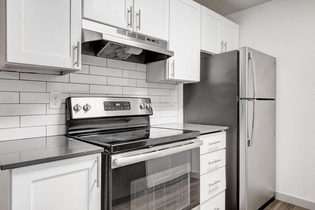 a kitchen with a stove and a refrigerator