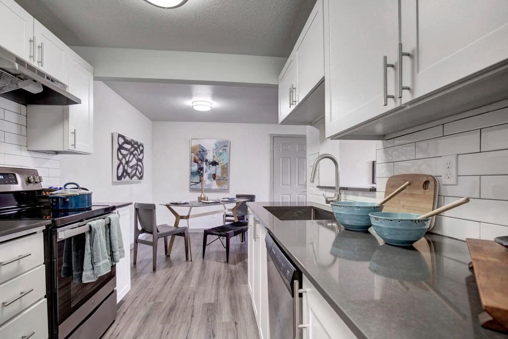 a kitchen and dining room with a table and chairs