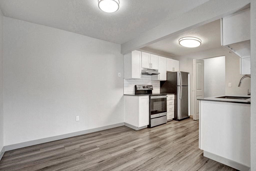 a kitchen with a stove top oven next to a refrigerator