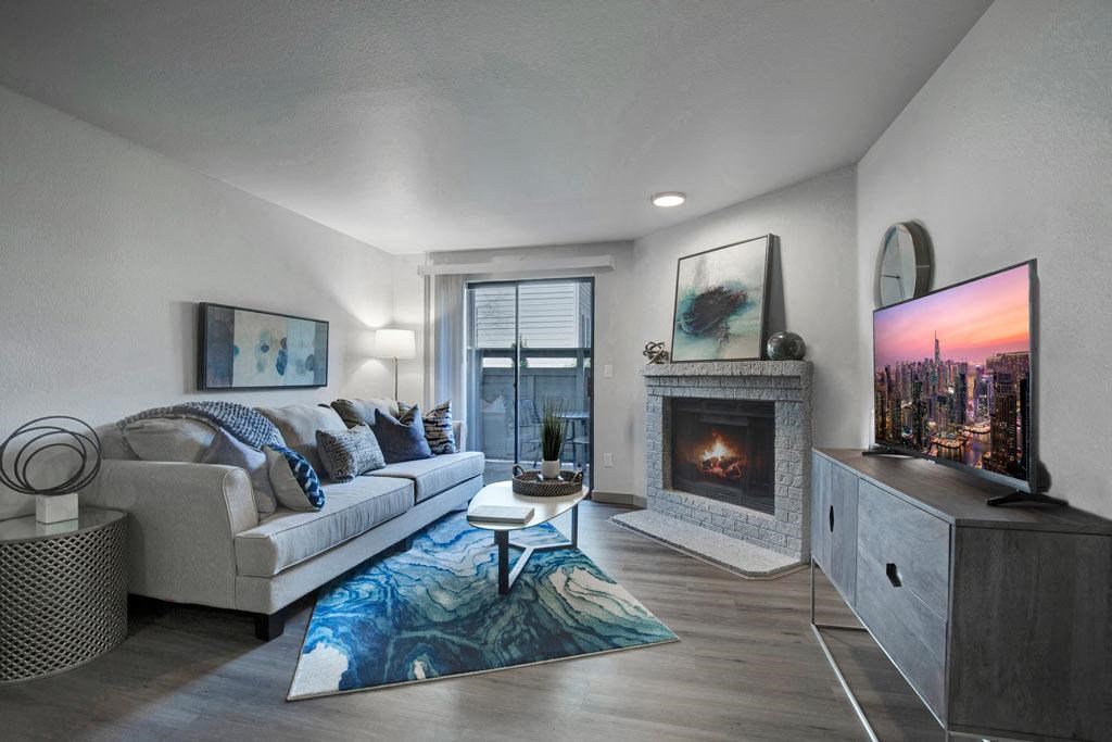 a living room with a couch a table and a fireplace