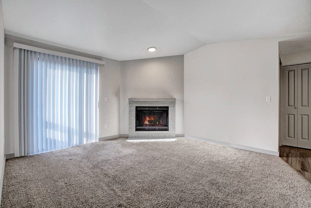 a living room with a fireplace and a window