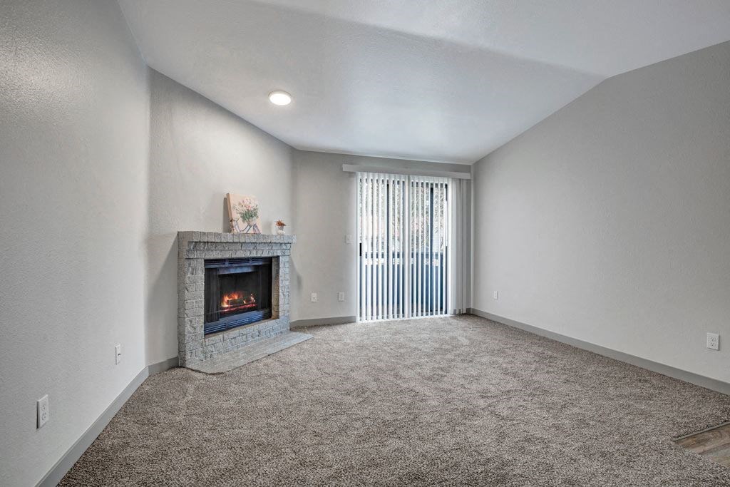 a living room with a fireplace and a window