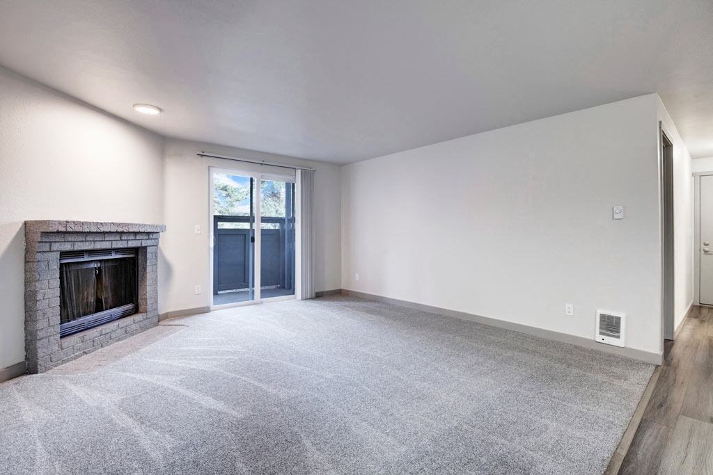 a living room with a fireplace and a door