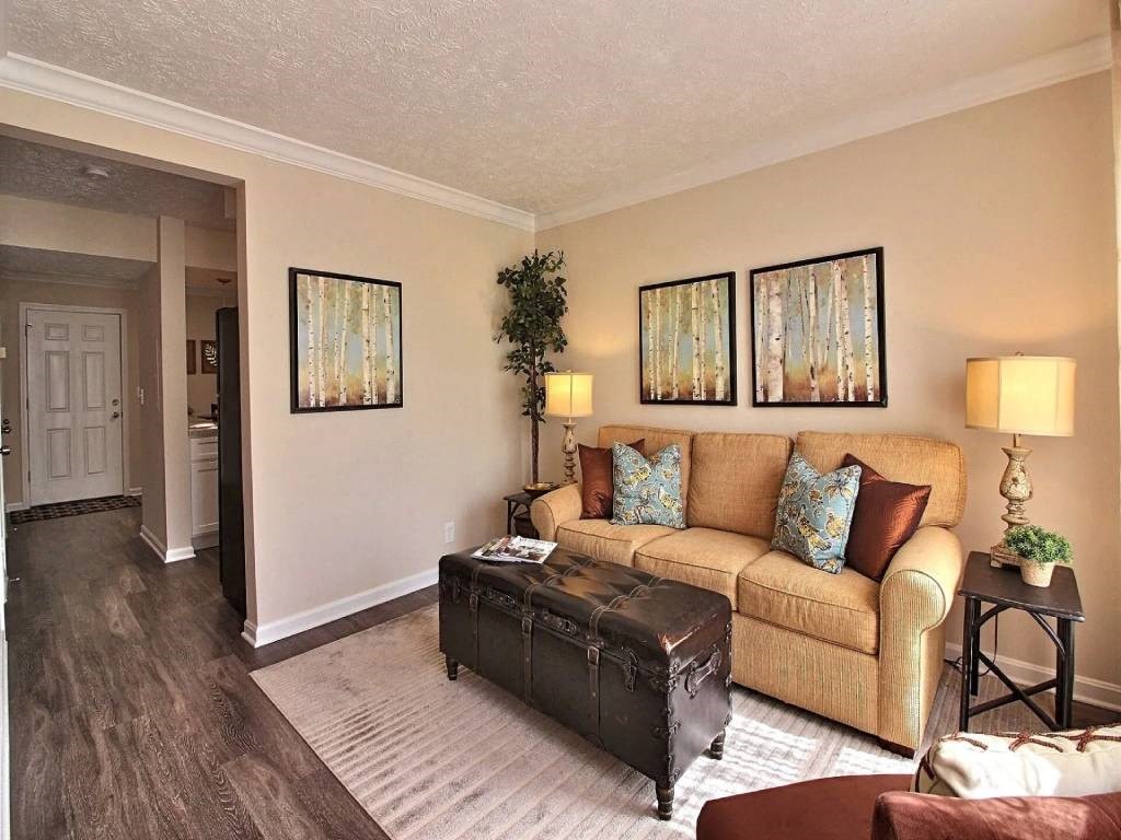 a living room with a couch and a suitcase