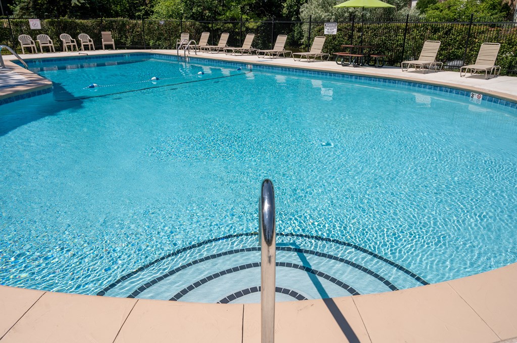 A swimming pool with a metal pole in the middle.