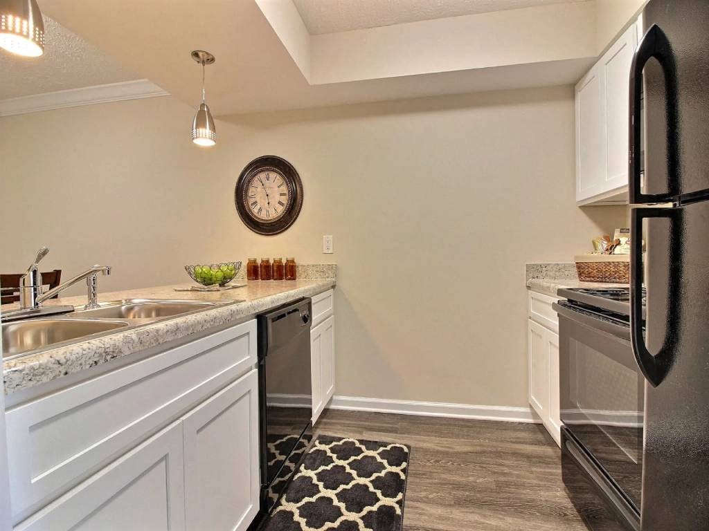 a kitchen with a sink and a clock on the wall
