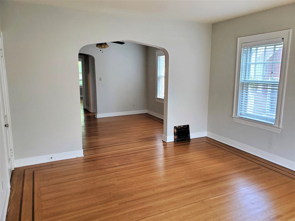 A room with wooden floors and white walls.