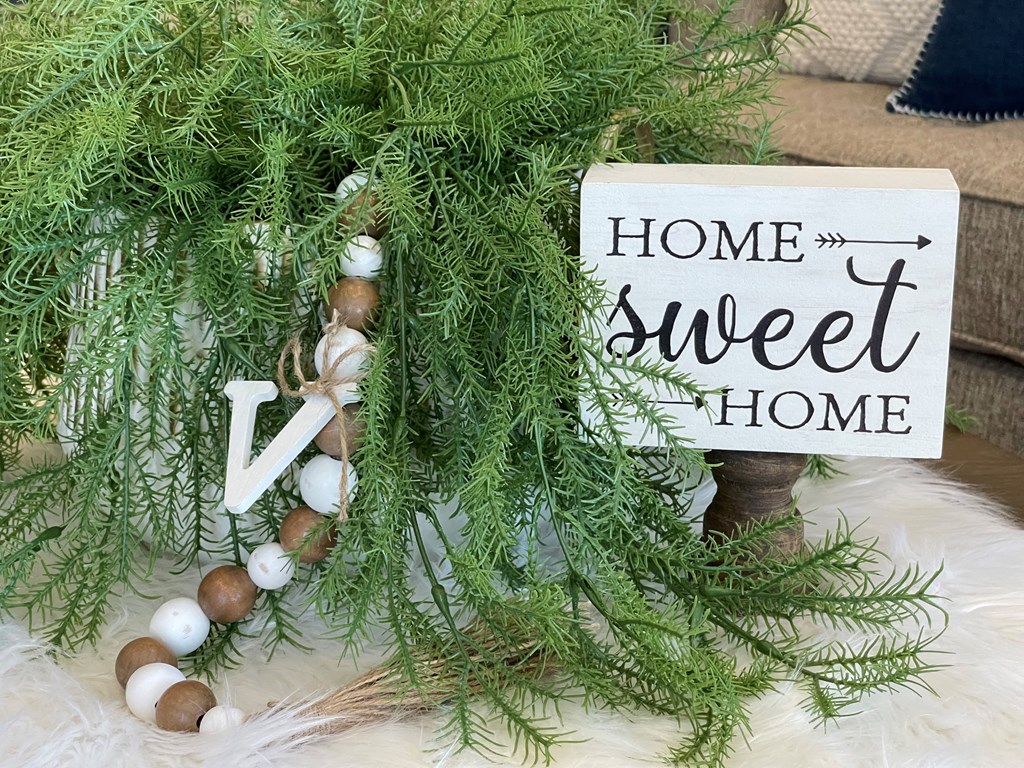 a christmas wreath with a sign that reads home sweet home