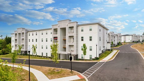 a street view of an apartment building with a road in front of it