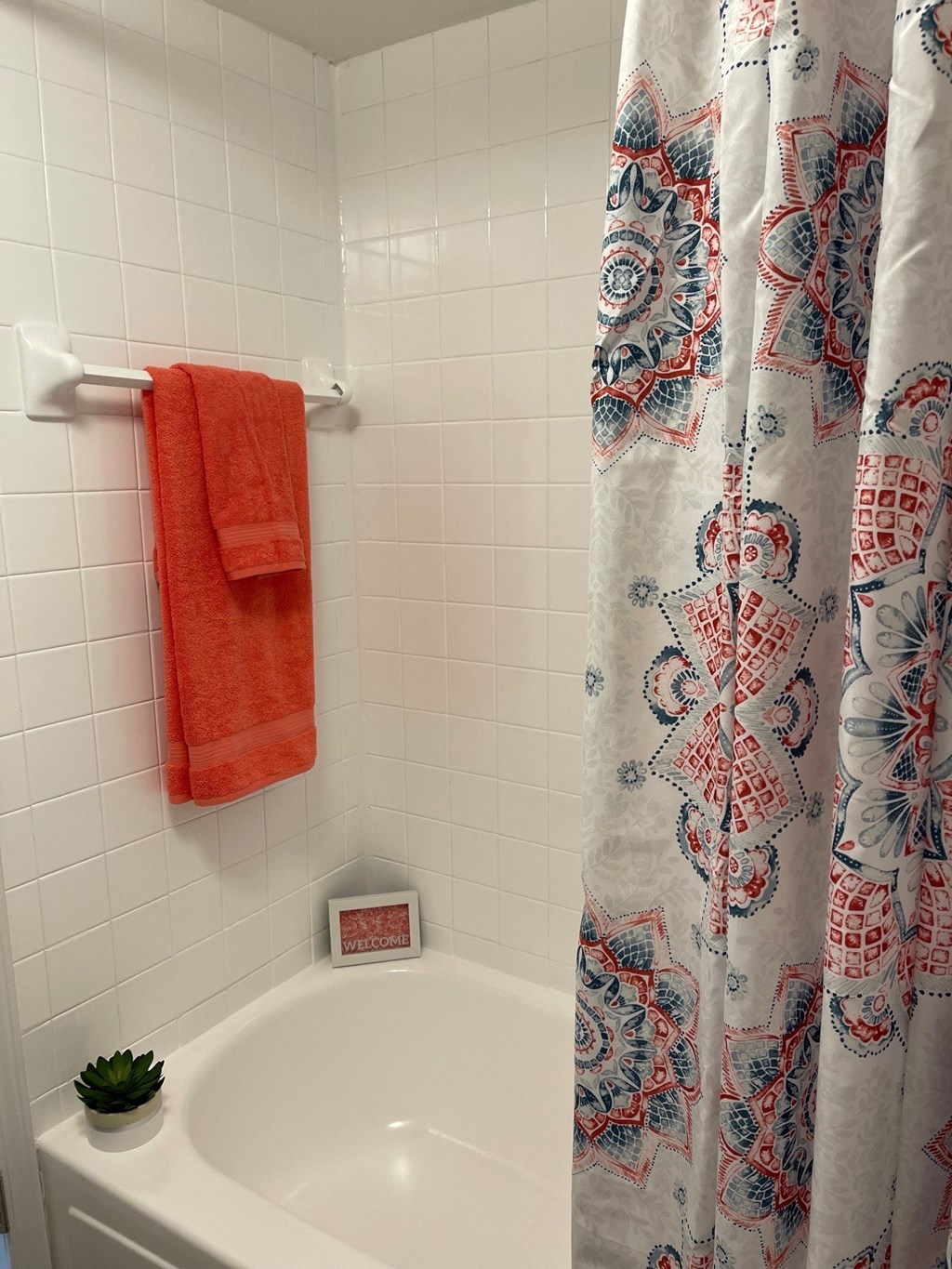 a bathroom with a shower curtain and a sink and a towel