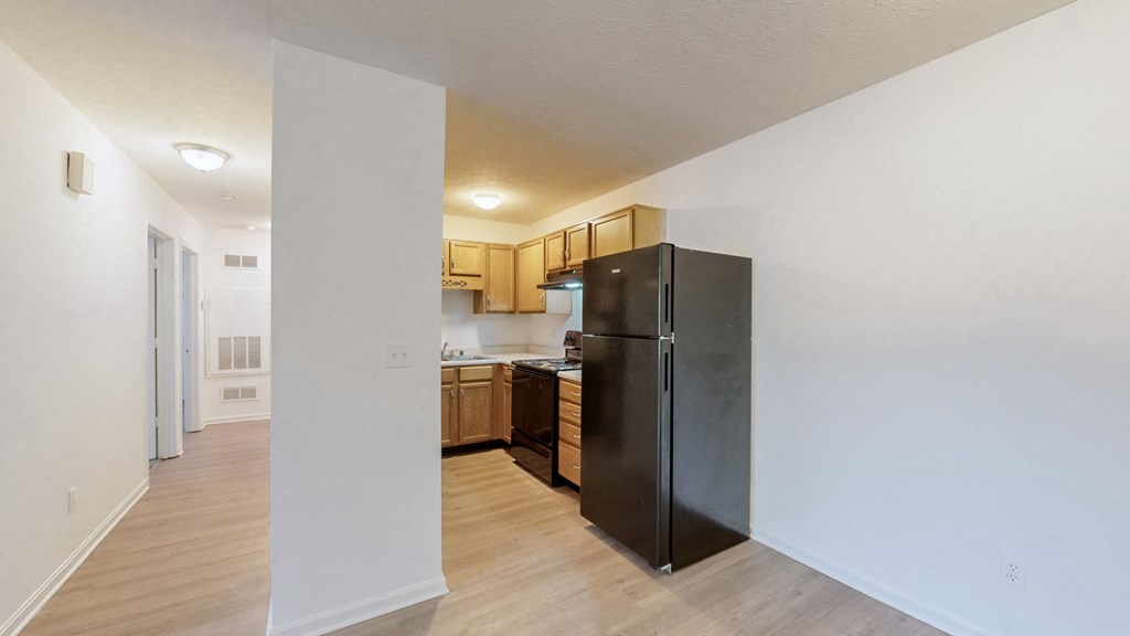 a kitchen with a refrigerator and a stove and