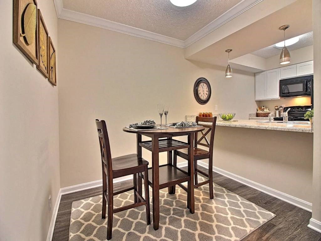 a dining room with a table and chairs