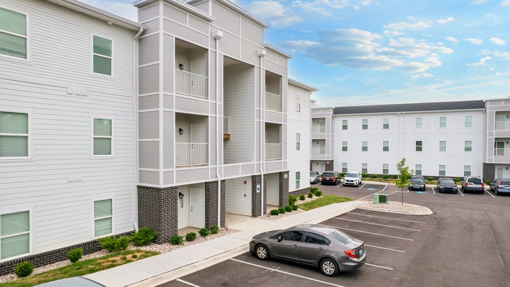a car parked in front of an apartment building
