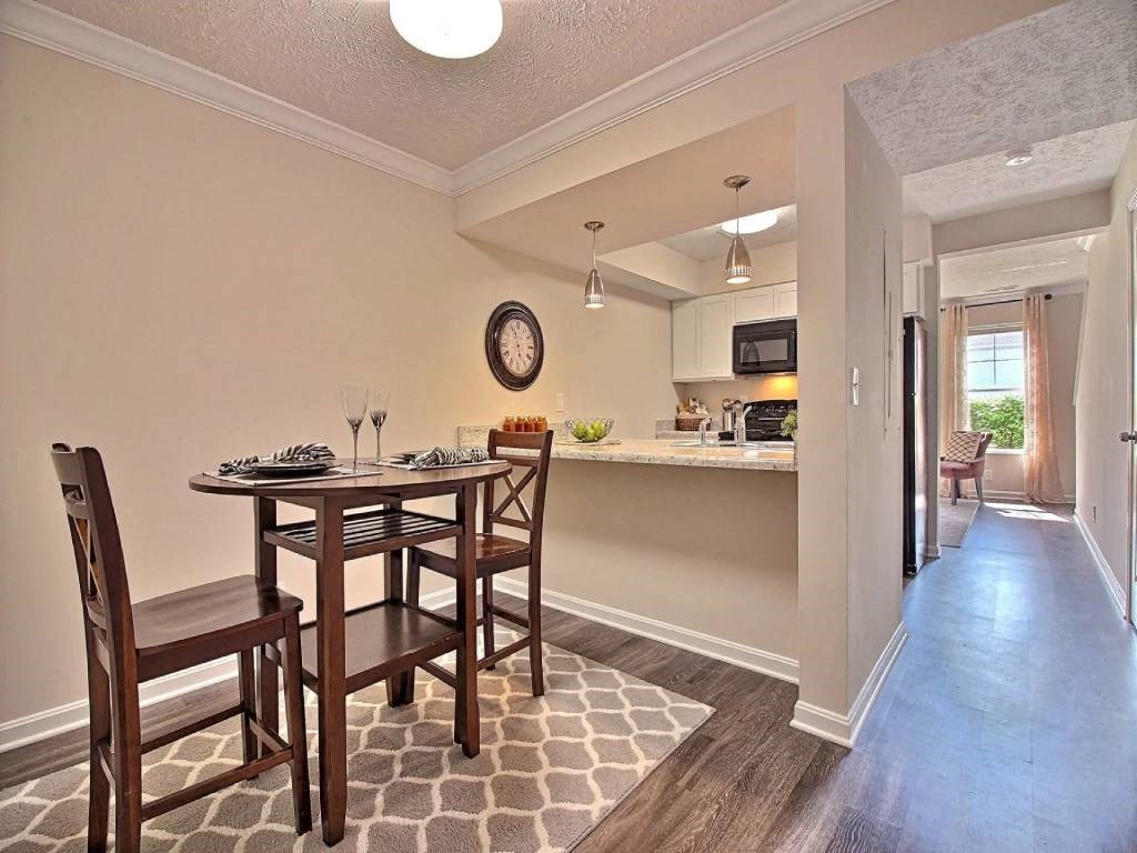 a dining room and kitchen with a table and chairs