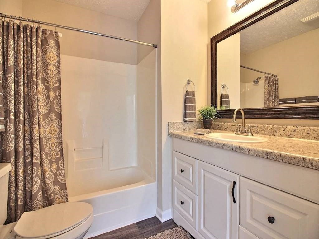 a bathroom with a sink toilet and a shower