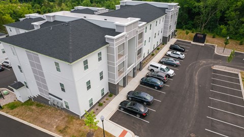 an aerial view of a building with cars parked in front of it