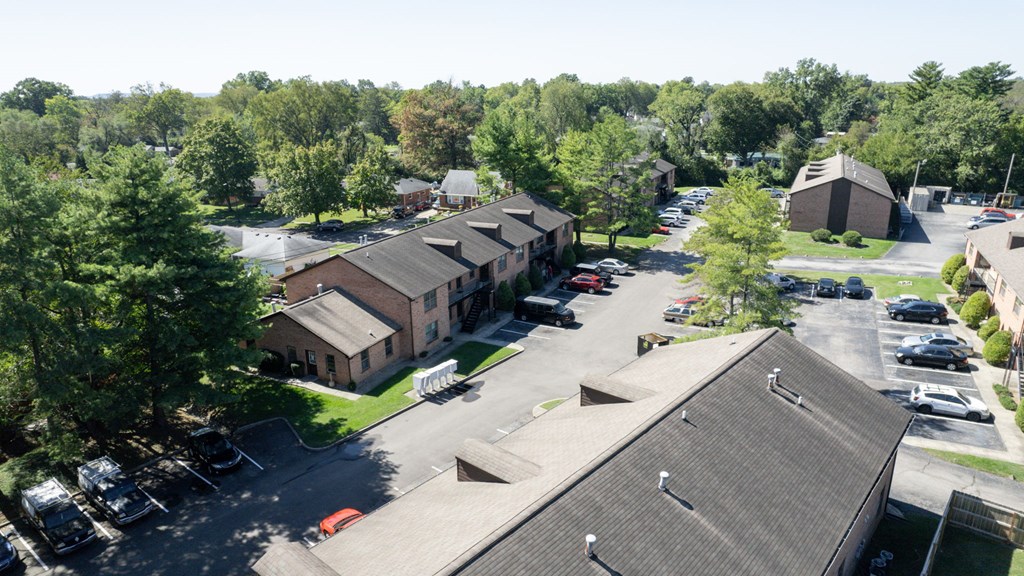 an aerial view of a parking lot and buildings
