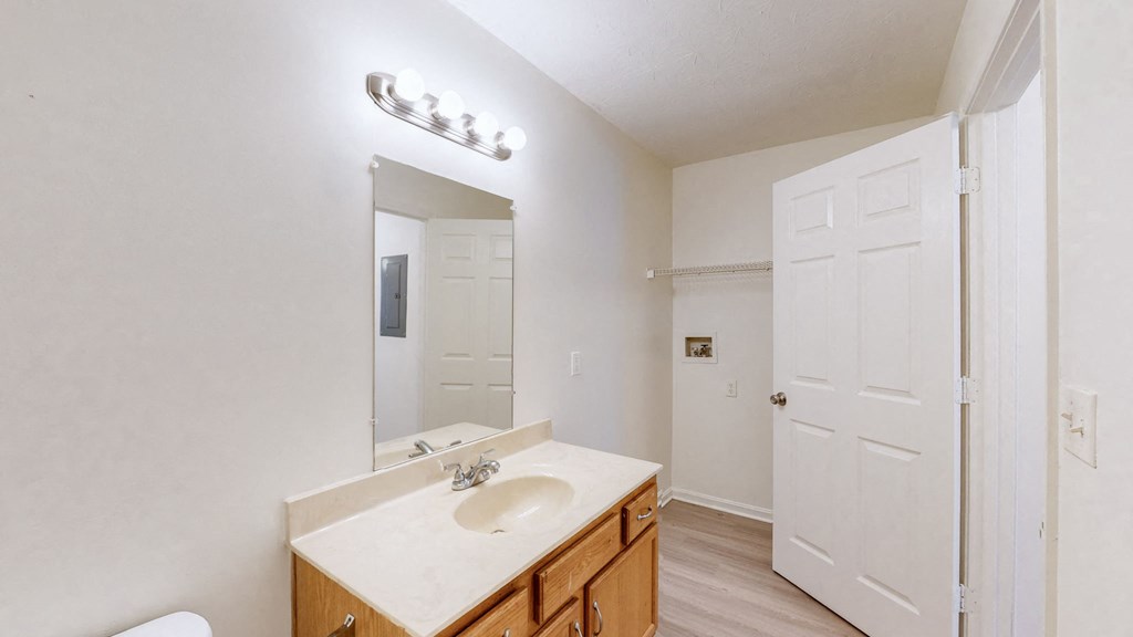 a bathroom with a white sink and a mirror