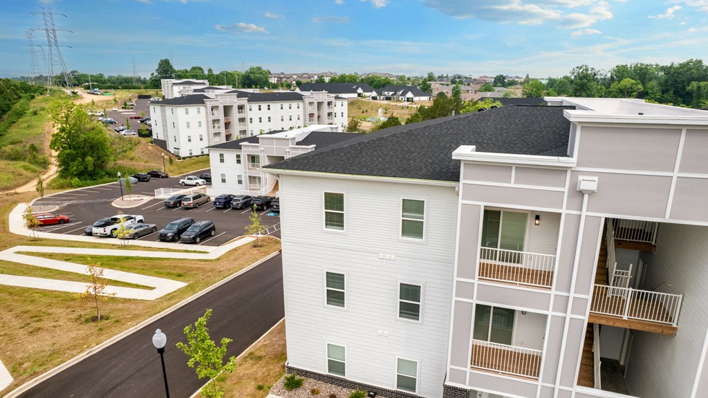 an aerial view of a building with a parking lot
