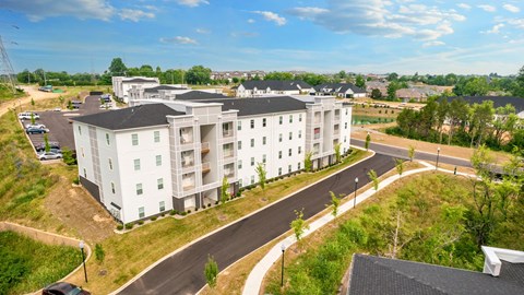 an aerial view of an apartment building on a street