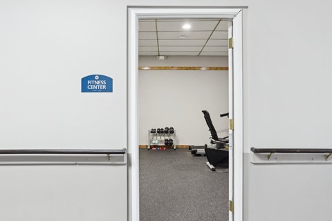 A fitness center sign is on the wall.