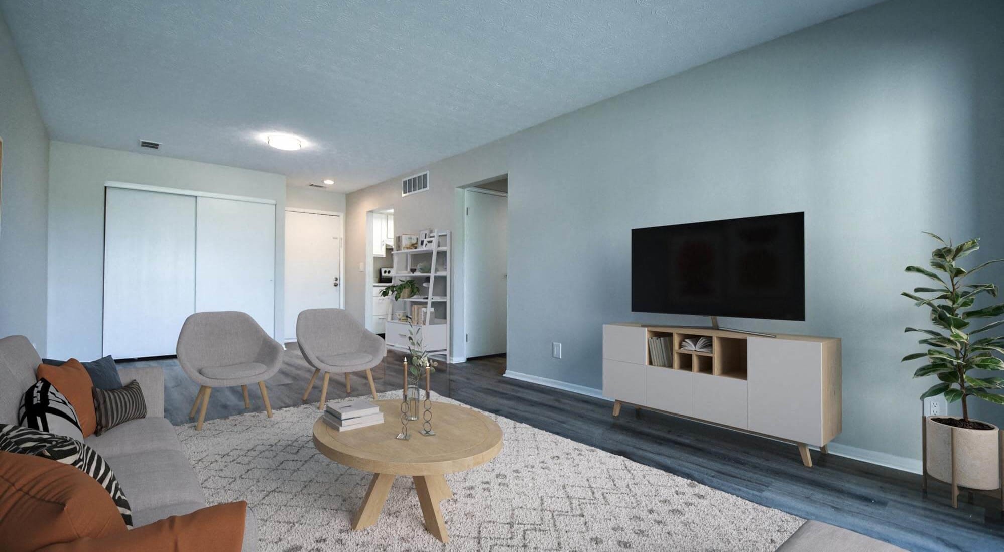 a living room with blue walls and a flat screen tv on the wall