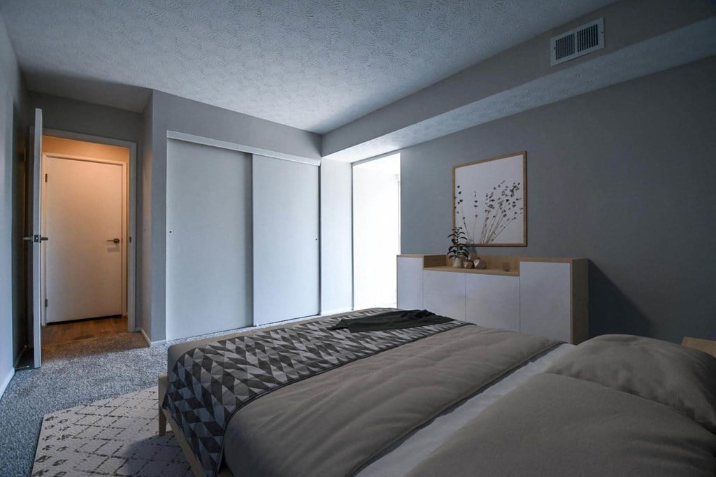 a bedroom with a bed in a room
