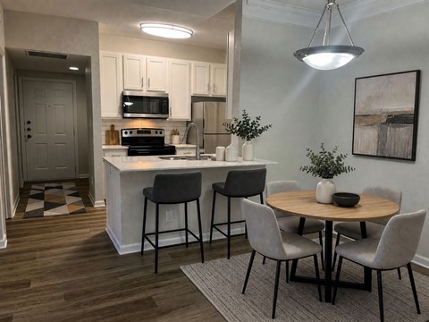 A kitchen with a table and chairs in the middle of the room.