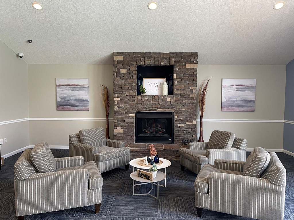 a living room with couches and chairs and a fireplace