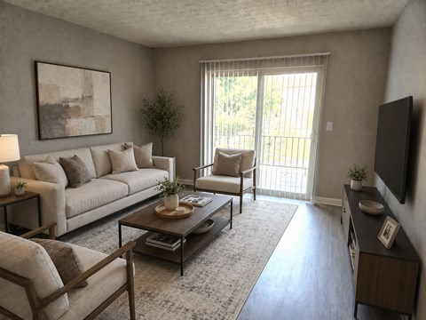 A living room with a couch, chair, and coffee table.