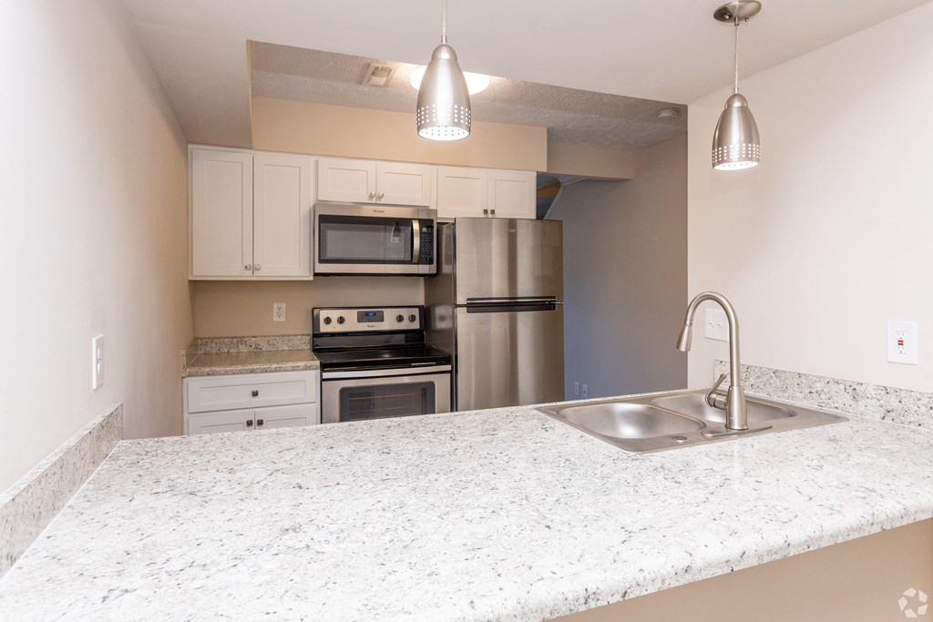 a kitchen with a granite counter top and stainless steel appliances