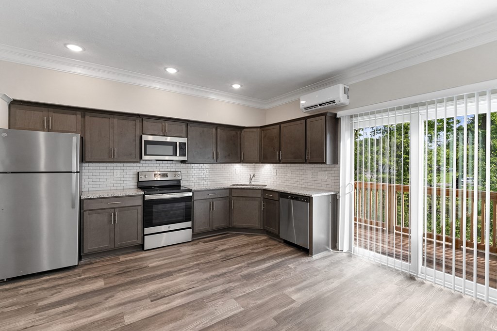 a kitchen with wooden cabinets and stainless steel appliances