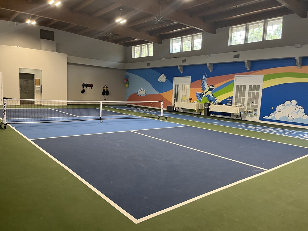 a tennis court with a tennis net in the middle of it