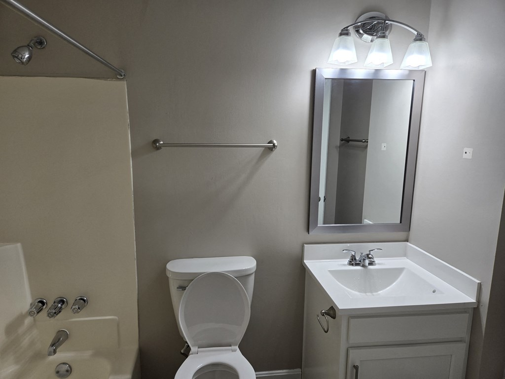 a small bathroom with a sink toilet and shower