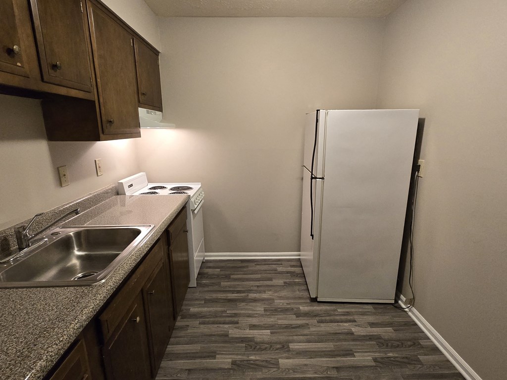 a kitchen with a sink and a refrigerator