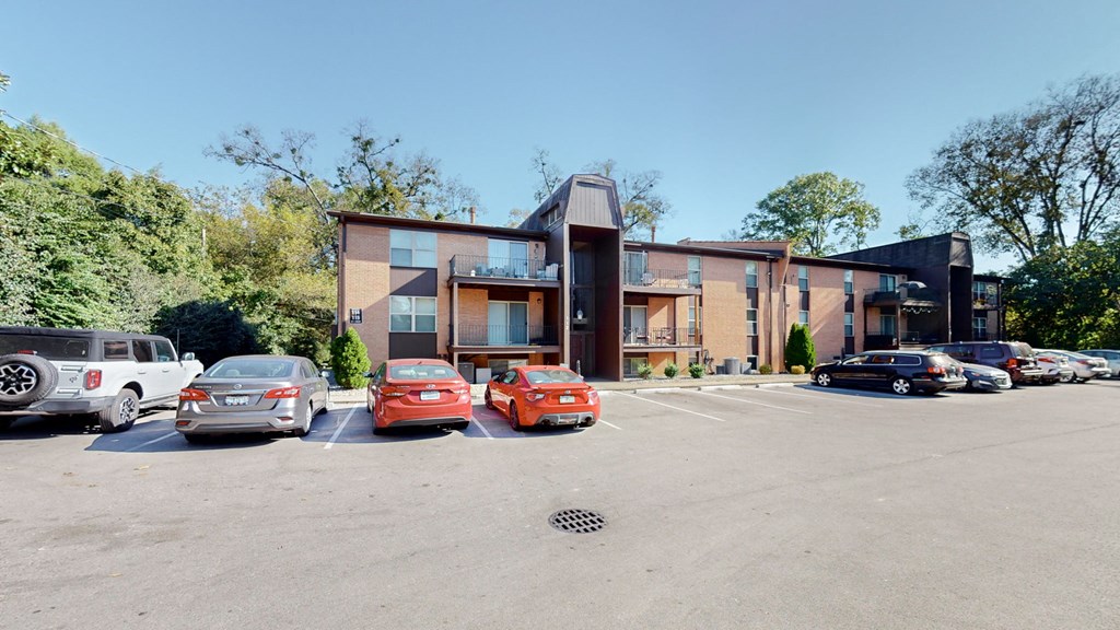a parking lot with cars in front of a building