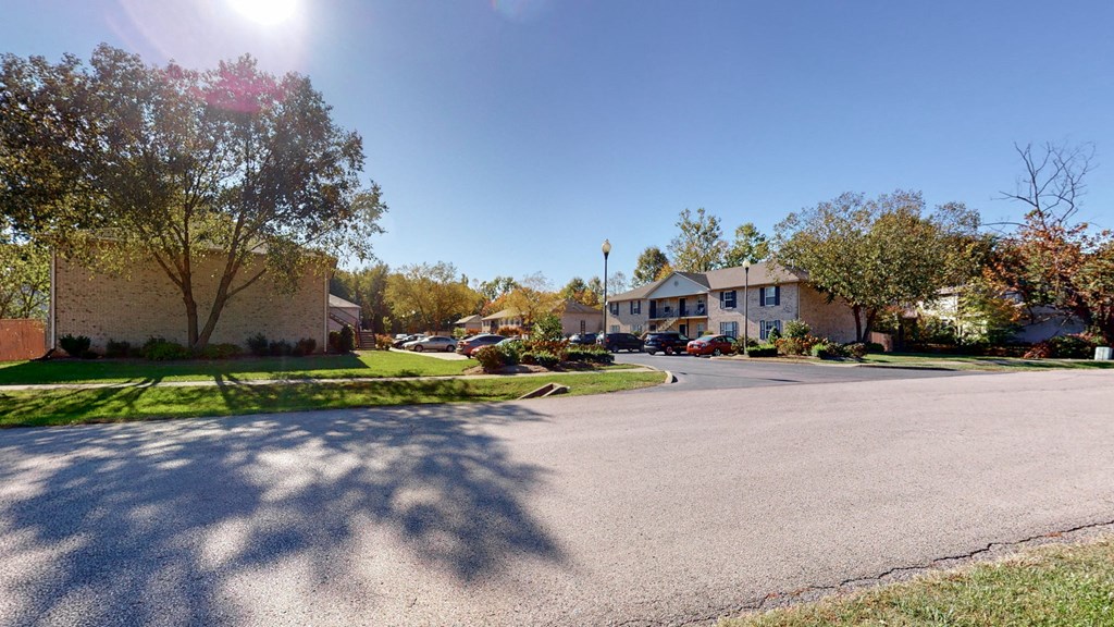 a street in a neighborhood with houses and trees