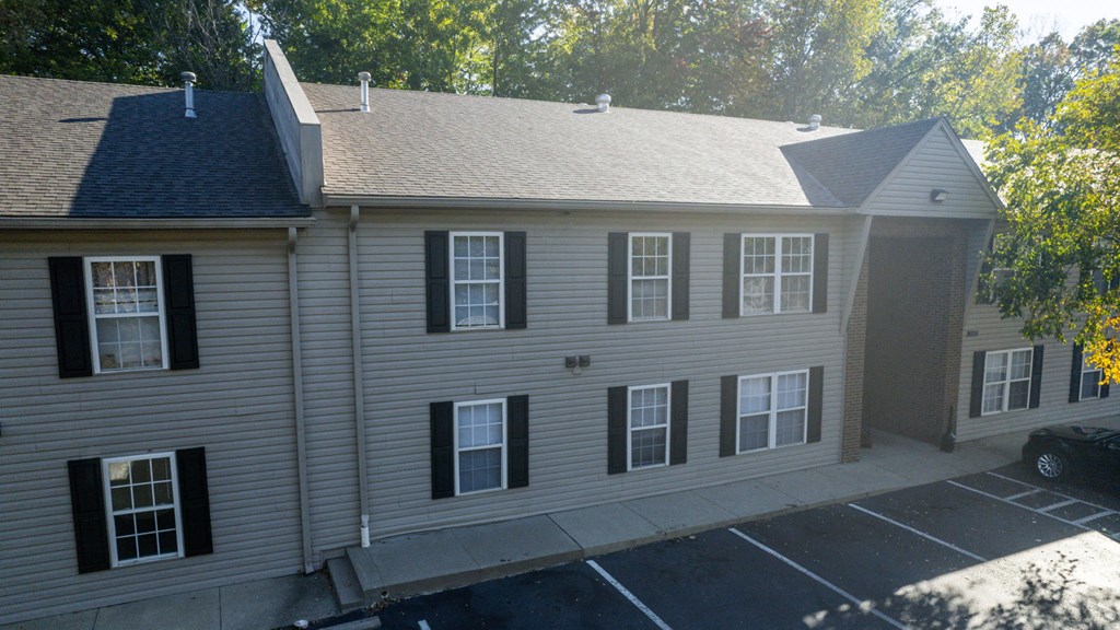 a view from above of a white house with a gray roof