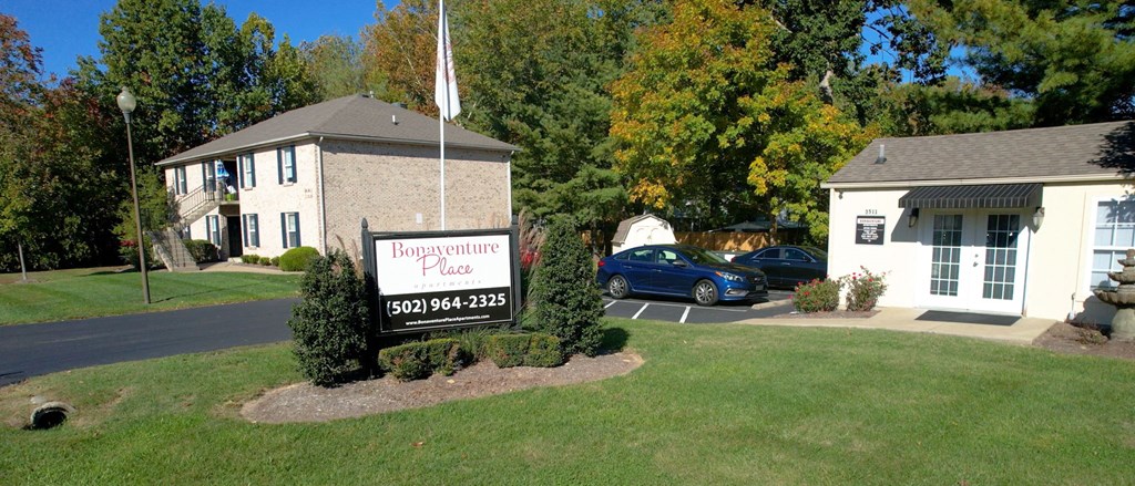 a property with a sign in front of a house