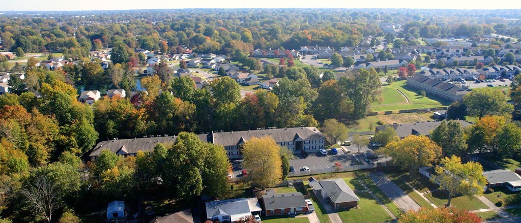 an aerial view of a building surrounded by trees