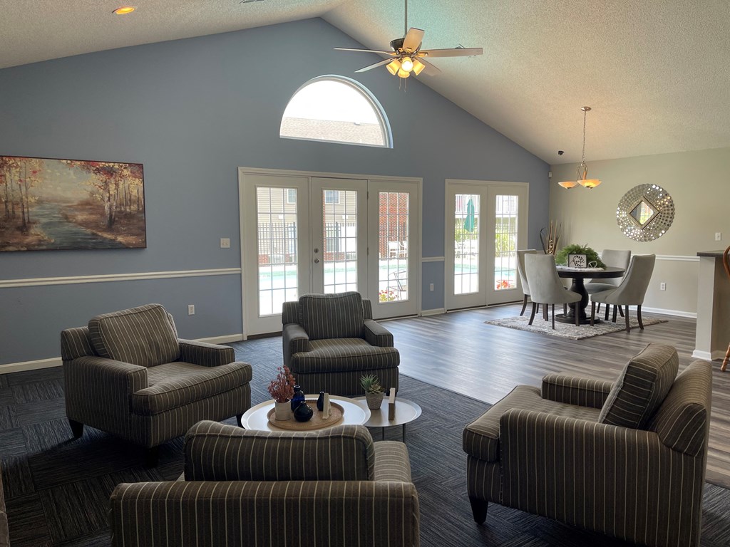 a living room with couches and a table and a ceiling fan