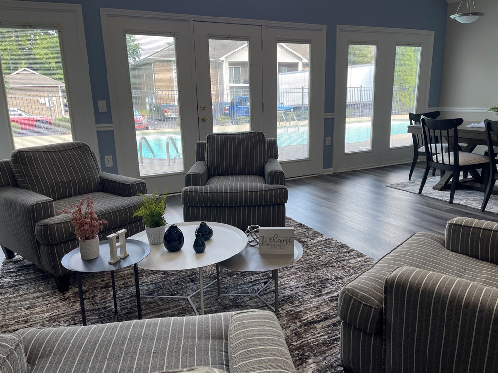 a living room with couches and chairs and a table
