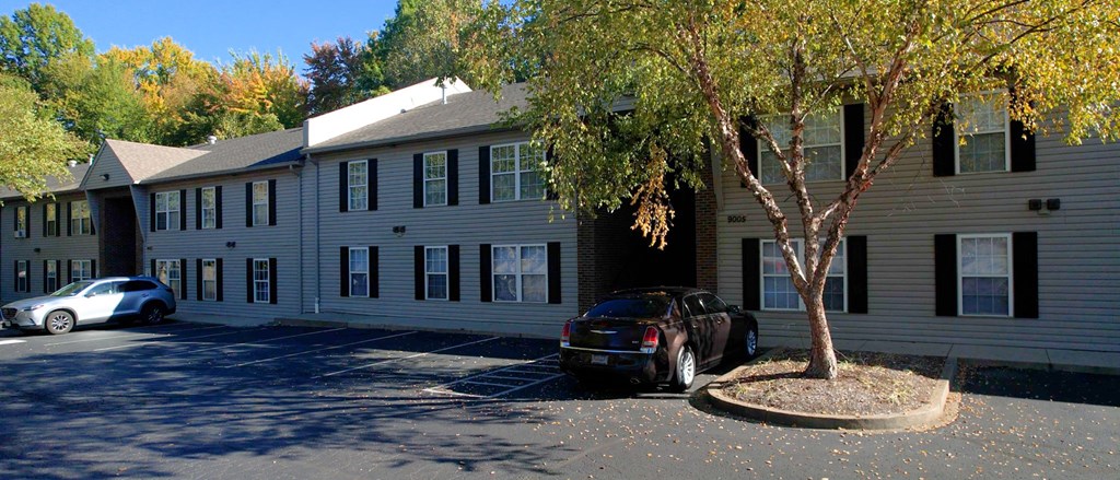 an apartment building with a car parked in front of it
