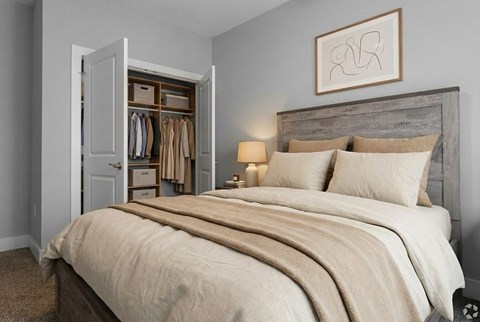 A bedroom with a large bed and a wooden headboard.