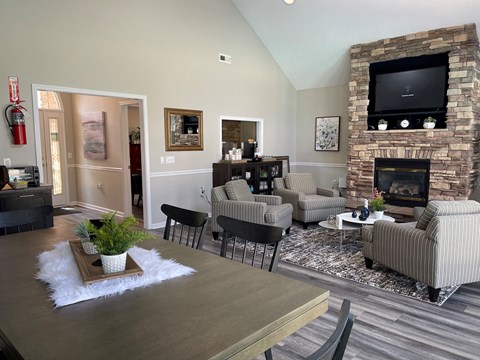 a living room with couches and a table and a fireplace