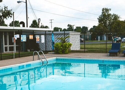 A pool with a ladder in the middle of it.