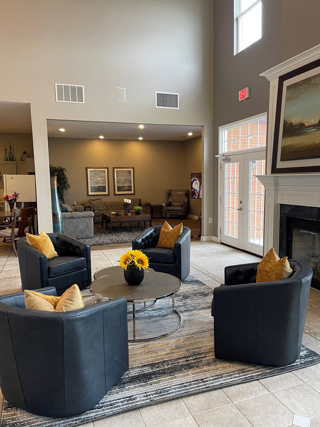 a living room with couches and chairs and a fireplace