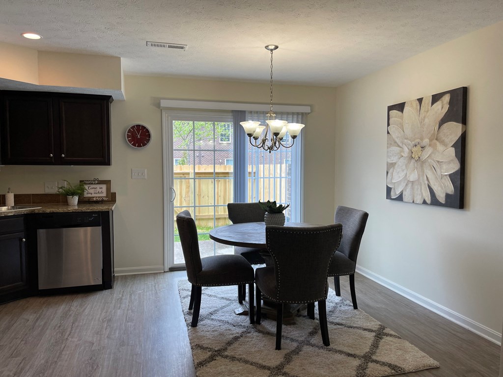 a dining room with a table and chairs and a window